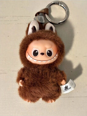 The Monsters Pin For Love Labubu Brown “L” Plush Keychain
